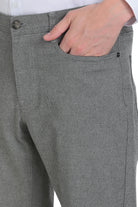 Gray textured trousers with a subtle woven pattern and dark button details.