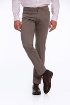 Khaki-colored, slim-fit men’s dress pants made of durable fabric with a classic five-pocket design.