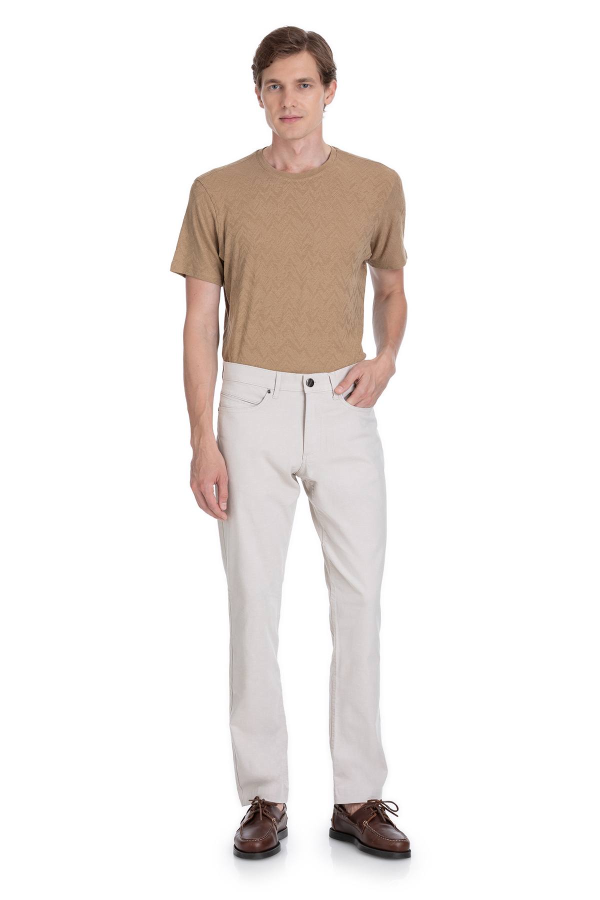 A pair of white, slim-fit chino trousers with a classic five-pocket design and button closure.