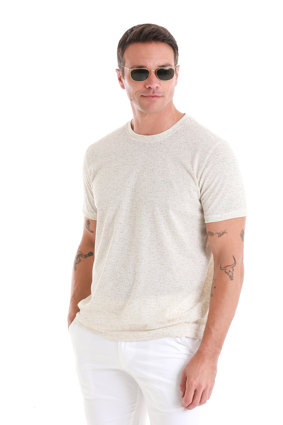 A light beige textured cotton t-shirt with a crew neck and short sleeves.