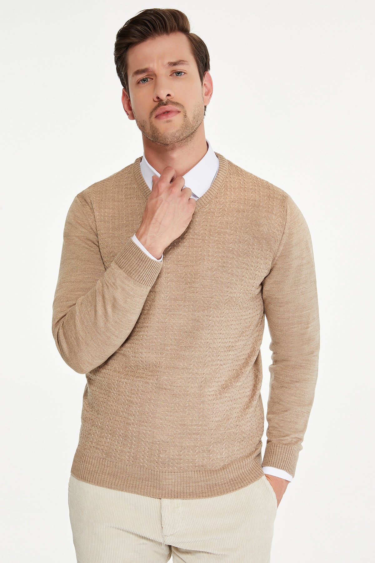 Beige textured knit sweater with ribbed cuffs and hem.