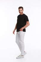 A man wearing a regular fit black basic cotton crew neck t-shirt with white jeans
