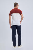A man wearing a regular fit crew neck t-shirt with a red and white color block design and short sleeves