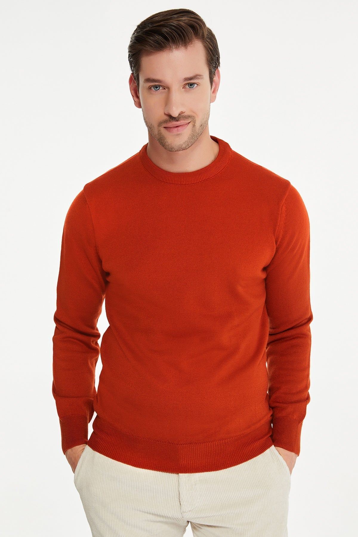 A men’s rust-orange ribbed knit sweater with a crew neckline and long sleeves.