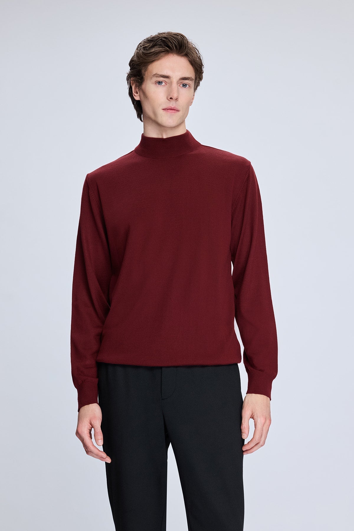 A sleek, deep burgundy long-sleeved turtleneck sweater with a smooth, fitted silhouette.