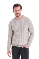 Beige cable-knit sweater with a ribbed crew neck and cuffs.
