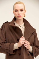 Brown woolen trench coat with a structured collar and double-breasted front.