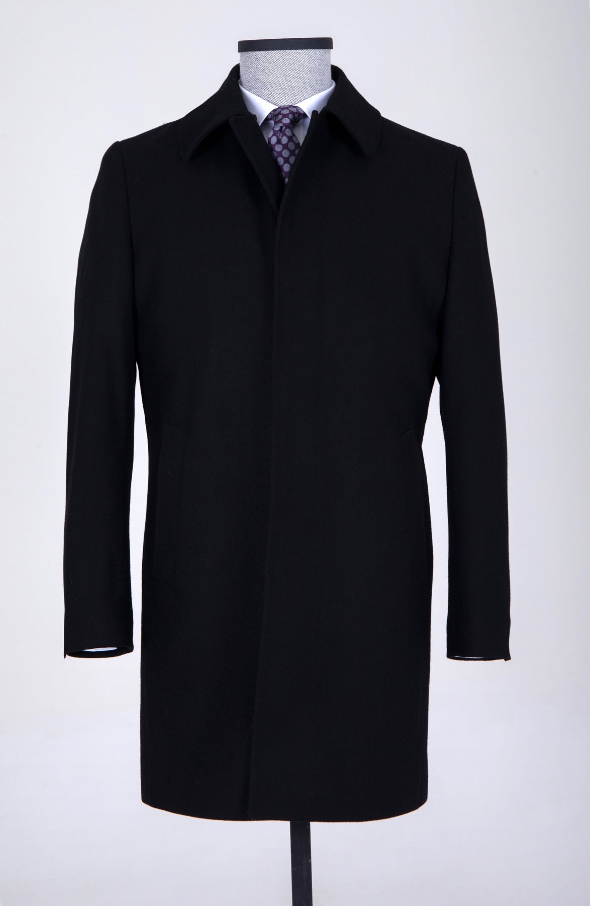Black wool overcoat with notched lapels and a single-breasted design.