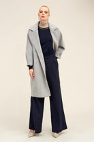 A stylish gray herringbone wool coat with a notched collar and long sleeves.