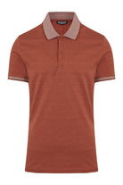 A rust-colored polo shirt with a subtle textured weave, featuring a contrasting beige collar and sleeve cuffs accented by fine horizontal stripes.