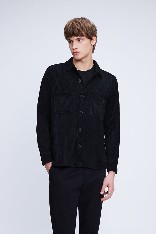 Black corduroy button-up shirt with two chest pockets and a subtle logo on the left breast.