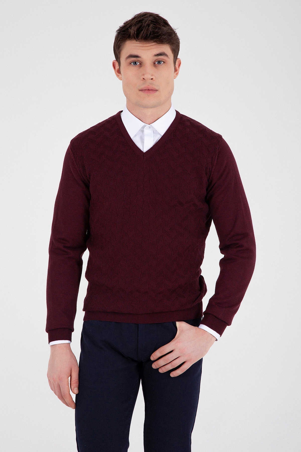Maroon v-neck sweater with ribbed texture and white cuffs.