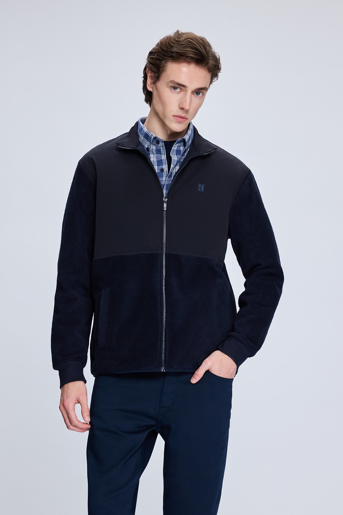 Dark navy zip-up fleece jacket with a subtle logo on the left chest.
