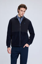 Dark navy zip-up fleece jacket with a subtle logo on the left chest.