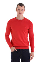 Red crewneck sweater with ribbed cuffs and hem, featuring a small embroidered logo on the left chest.