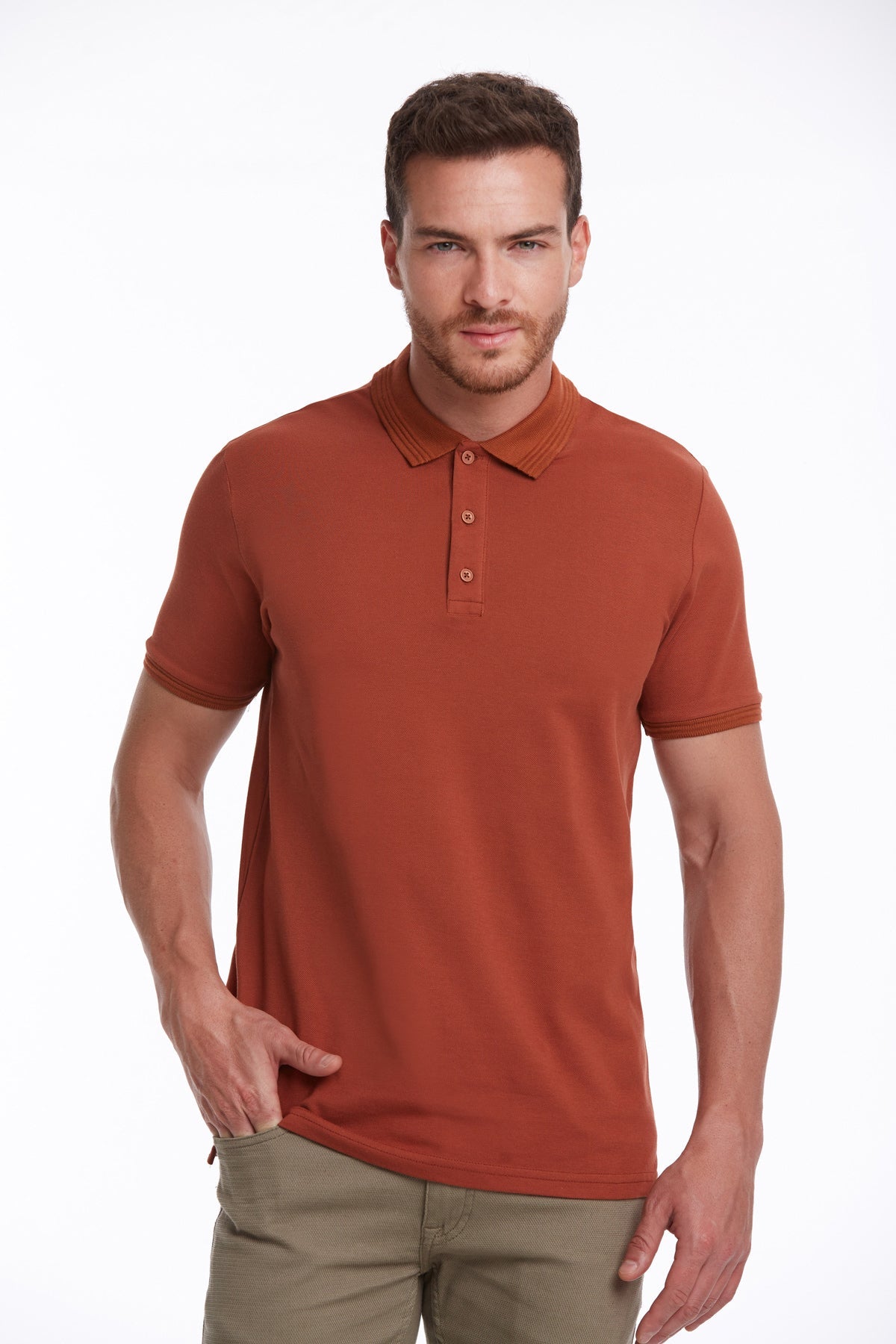A man wearing a rust-colored, short-sleeved polo shirt with a ribbed collar and matching button placket.