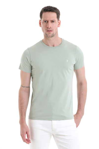 A slim-fit, light sage green cotton t-shirt with a subtle white logo on the left chest.