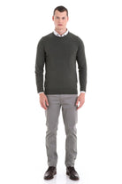 Dark olive green crewneck sweater with ribbed cuffs and hem.