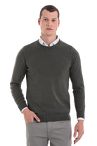 Dark olive green crewneck sweater with ribbed cuffs and hem, featuring a subtle embroidered logo on the left chest.