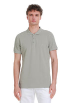 A men’s olive green polo shirt with a subtle embroidered logo on the chest.