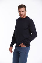 A navy blue long-sleeved crewneck sweater.