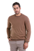 A men’s brown crewneck sweater with ribbed cuffs and hem.