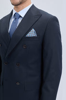 Navy blue regular fit double breasted suit jacket with peak lapel black buttons and patterned pocket square