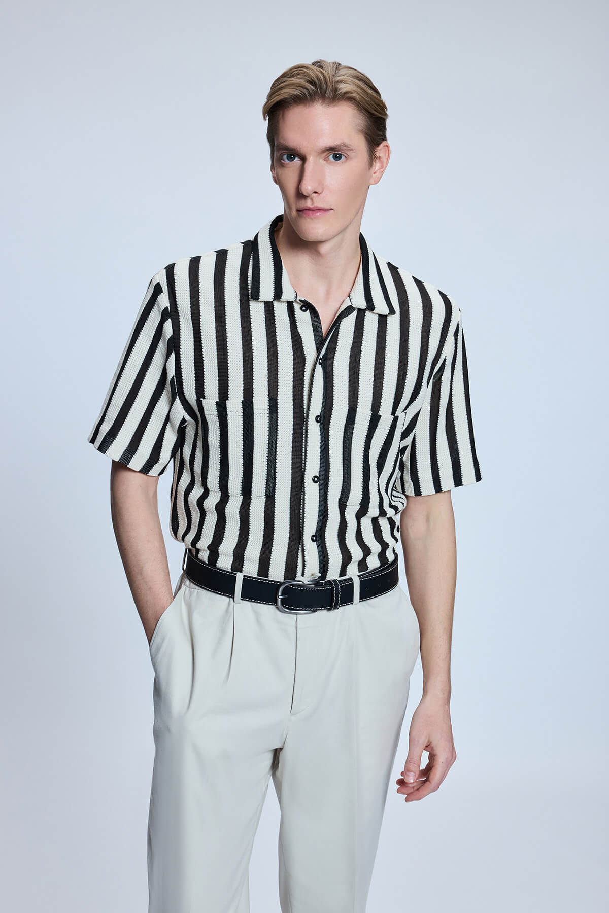 Black and white vertically striped short-sleeved button-up shirt.
