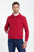 Red zip-up jacket with a collar and two front pockets, one featuring a zipper closure.