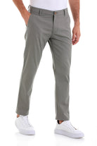 Gray chino trousers with a slim fit and subtle pleats at the front.