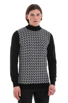 Black and gray geometric-patterned knit vest worn over a black turtleneck sweater.