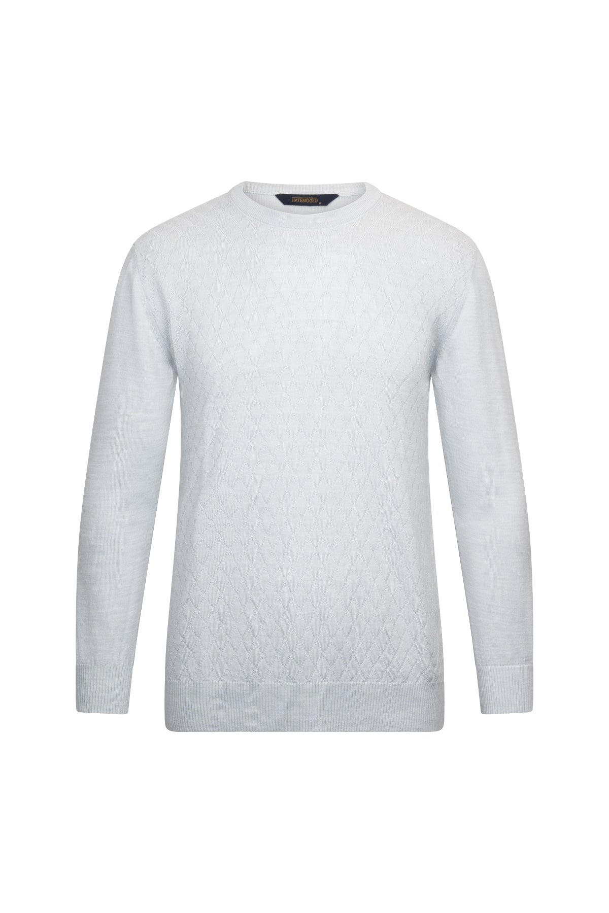 A minimalist white crewneck sweater with a subtle textured pattern across the lower front and ribbed cuffs and hem.