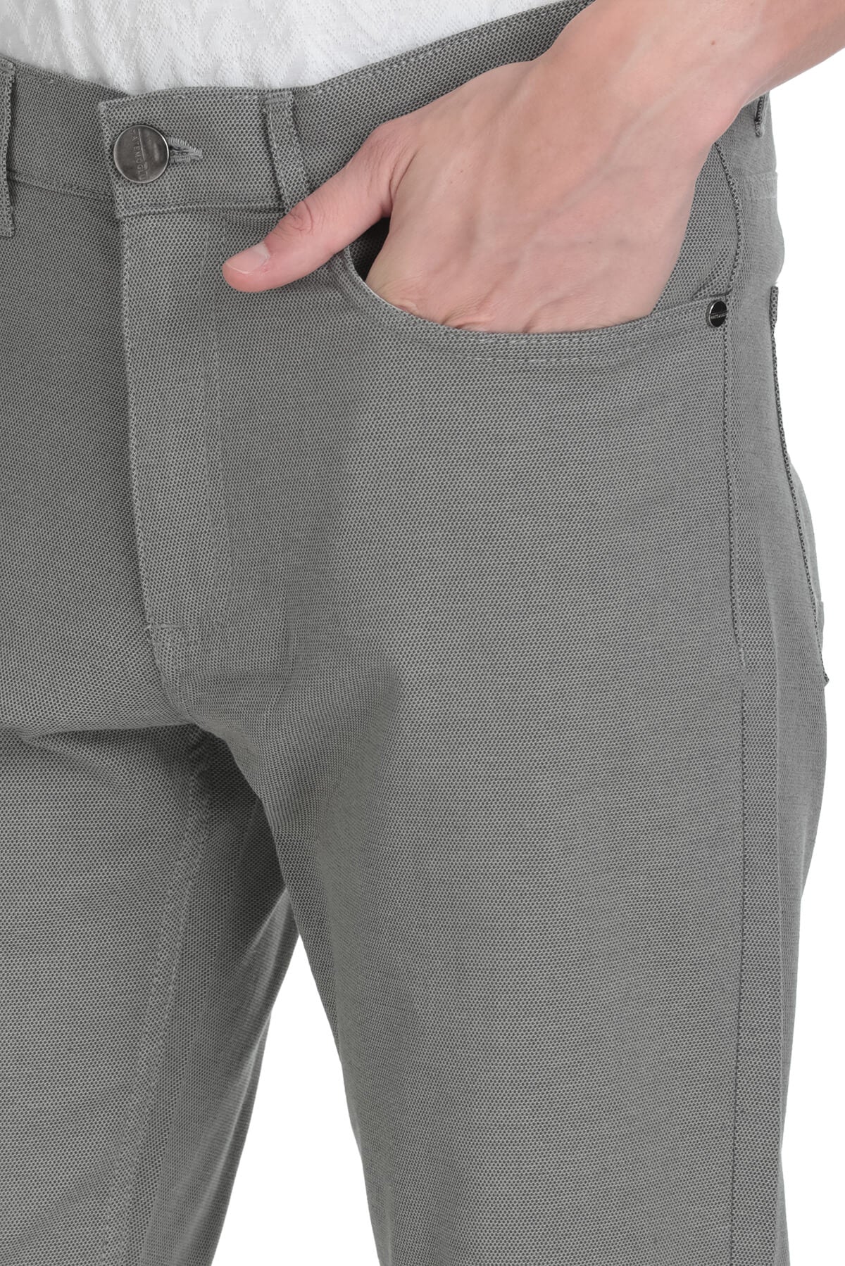 Gray textured fabric trousers with a subtle woven pattern and a button closure.