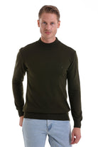 Dark olive green turtleneck sweater with ribbed cuffs and hem.
