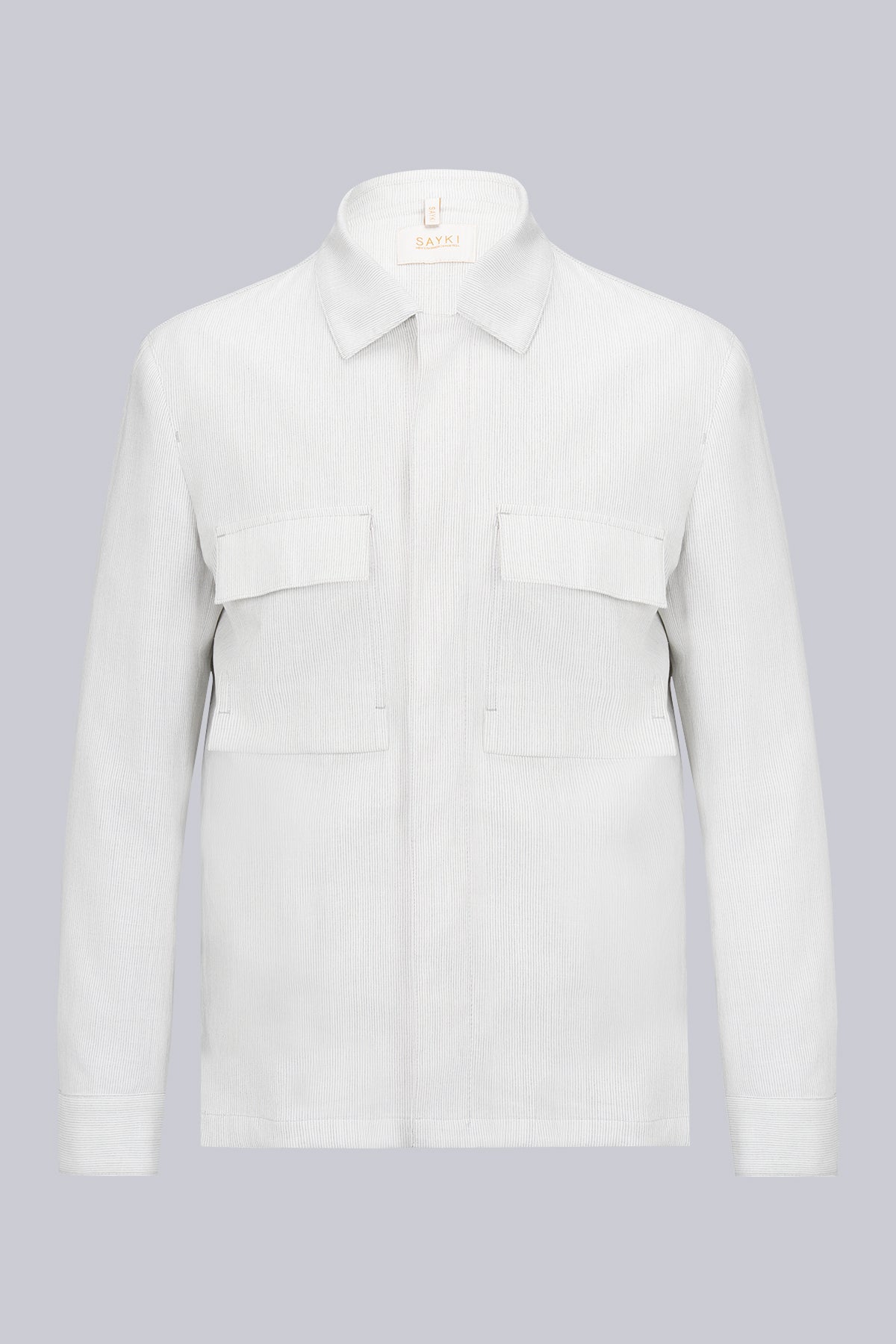 A crisp white corduroy shirt with a classic collar and two flap pockets on the chest.