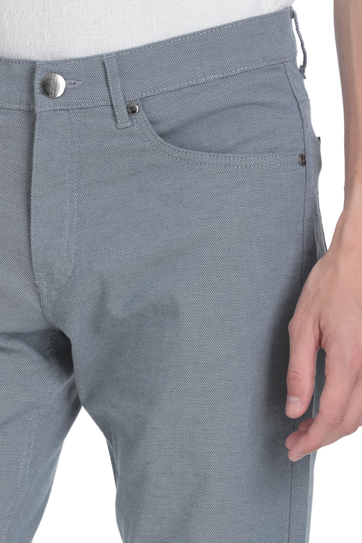 Gray textured denim jeans with a subtle woven pattern and silver-toned button closure.