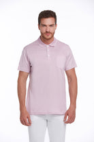 A light pink short-sleeved polo shirt with a collar, buttoned placket, and a single chest pocket.