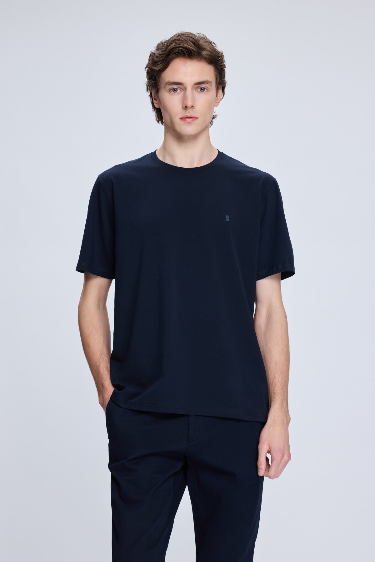 Navy blue short-sleeved crew neck t-shirt with subtle embroidered logo on the left chest