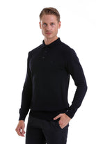 Black long-sleeved polo shirt with a classic collar and subtle buttoned placket.