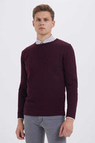 Maroon cable-knit sweater with ribbed cuffs and neckline.