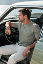 A man wearing a regular fit rayon khaki crewneck t-shirt with an intricate geometric pattern in light gray