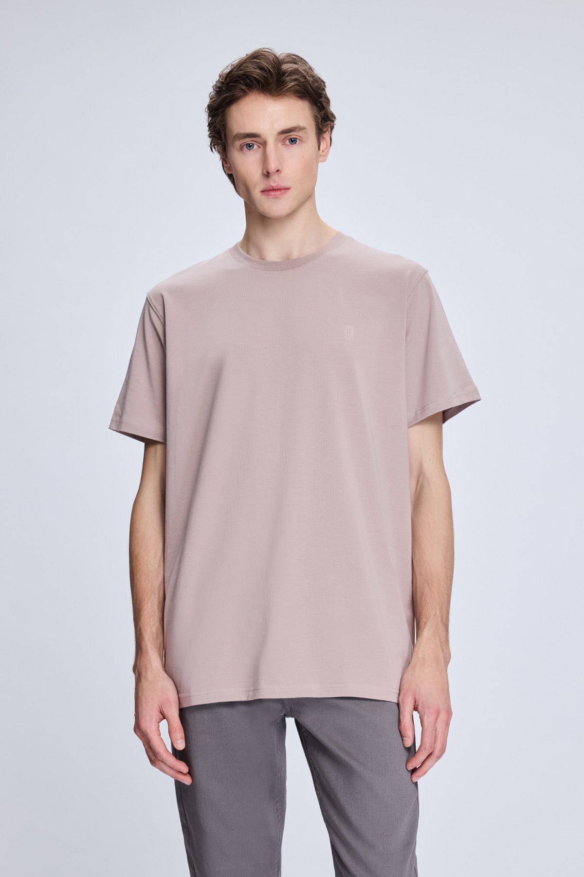 A soft mauve-colored, minimalist short-sleeved t-shirt with a relaxed fit.