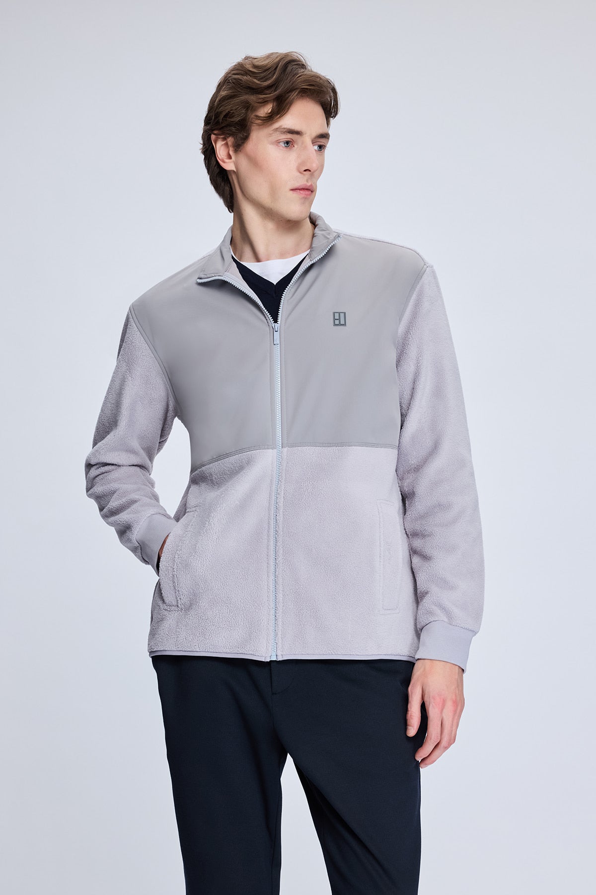 Gray two-tone fleece zip-up jacket with a subtle textured pattern and a small logo on the left chest.