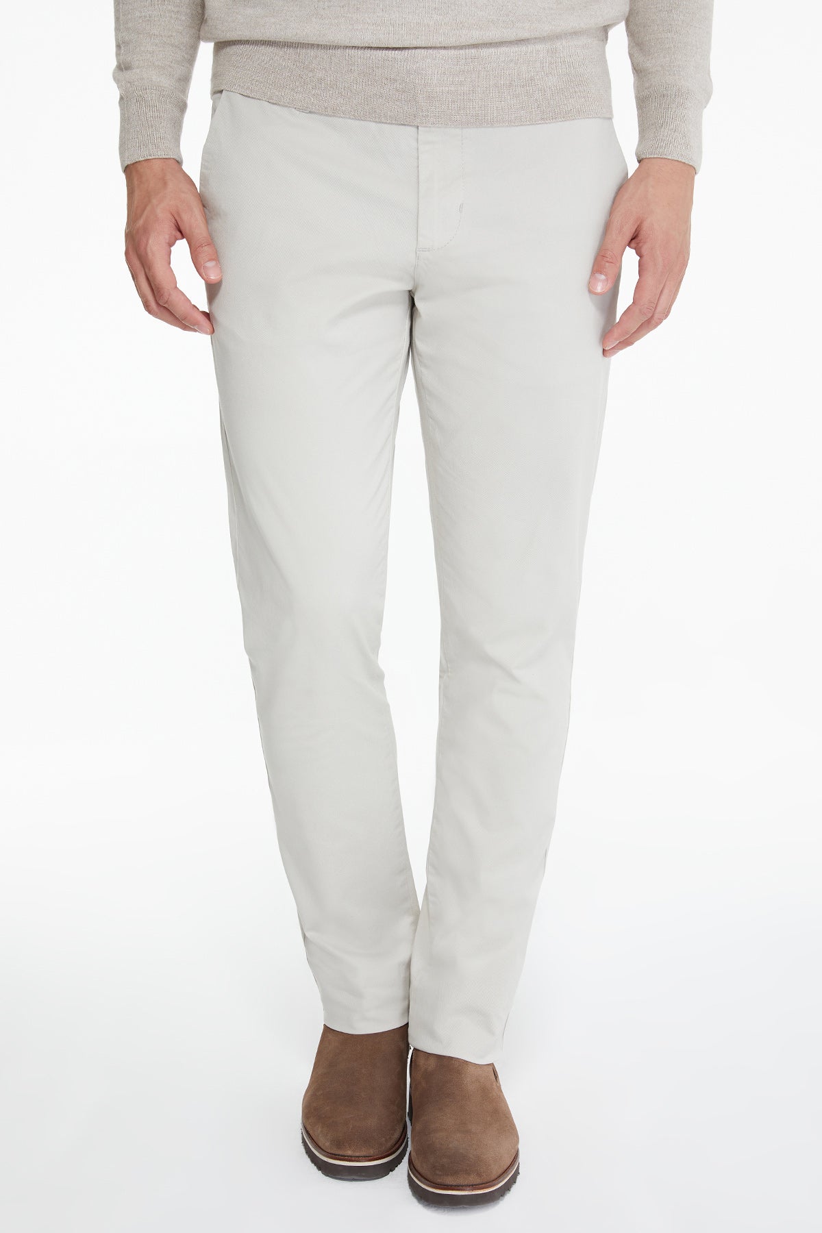 Beige slim-fit chinos made of a smooth, lightweight fabric with clean tailoring and subtle creases.