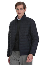 Dark navy quilted puffer jacket with a high collar and front zipper.