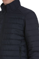 Dark navy quilted puffer jacket with a high collar and black zipper accents.