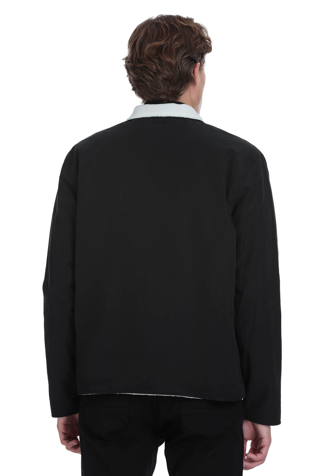 Black wool-blend jacket with a crisp white collar and subtle contrast stitching along the hem.