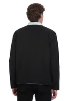 Black wool-blend jacket with a crisp white collar and subtle contrast stitching along the hem.