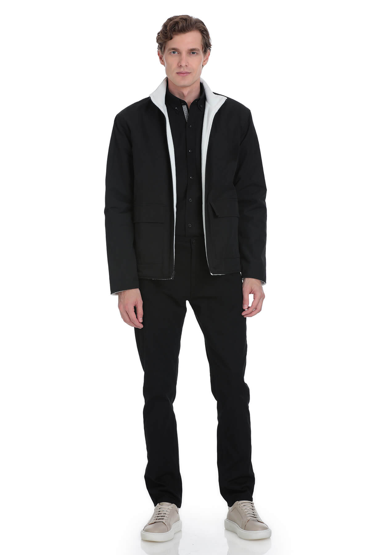Black quilted jacket with white shearling lining and zipper accents.
