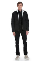 Black quilted jacket with white shearling lining and zipper accents.